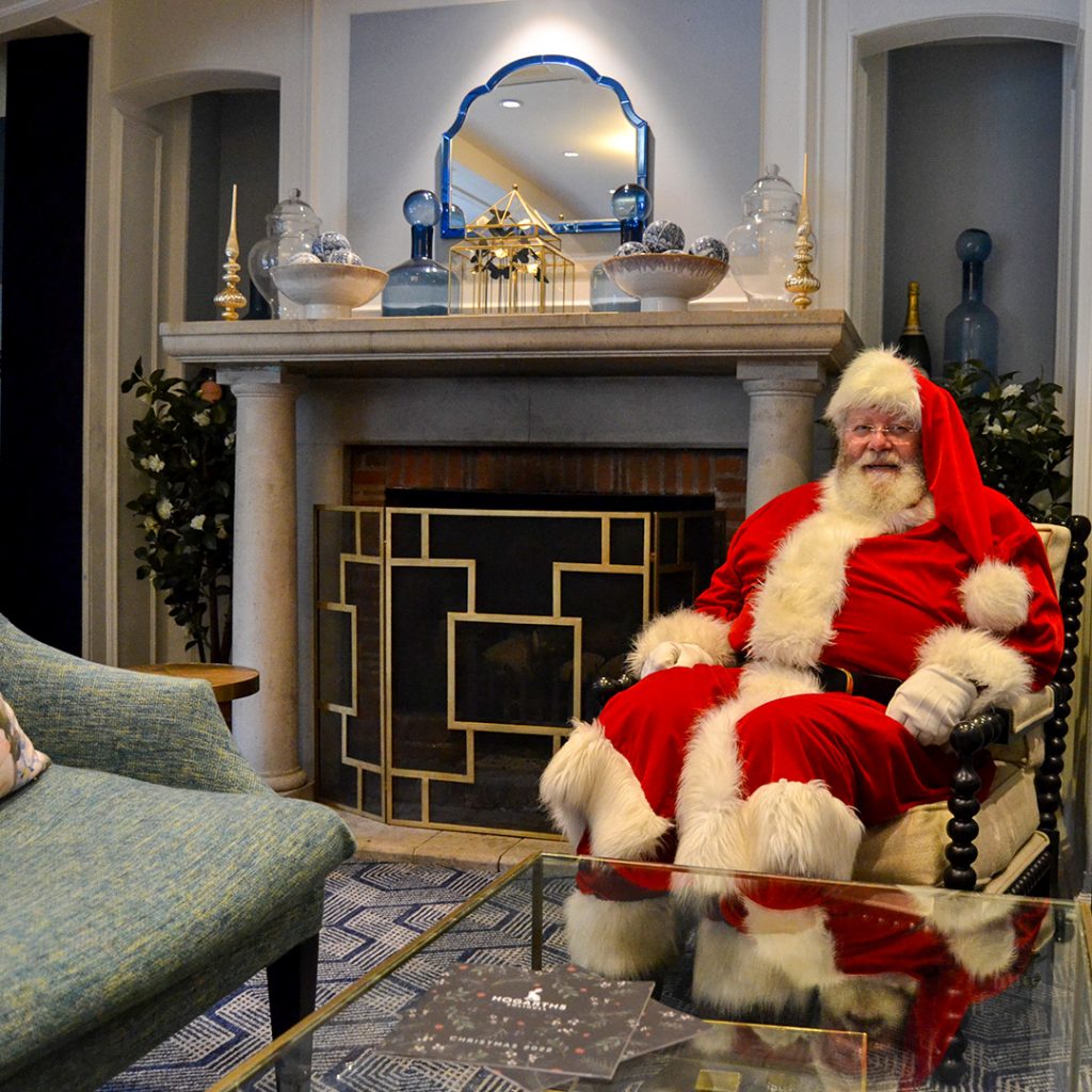 Father Christmas in front of fireplace at Hogarths Solihull