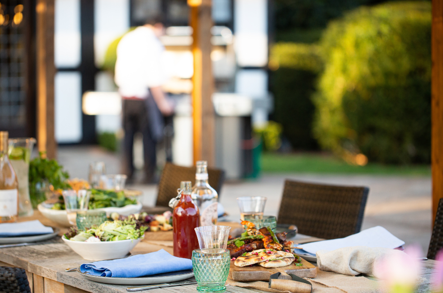 Alfresco dining setup at Stone Manor with grilled dishes and drinks, perfect for casual celebrations or summer weddings.