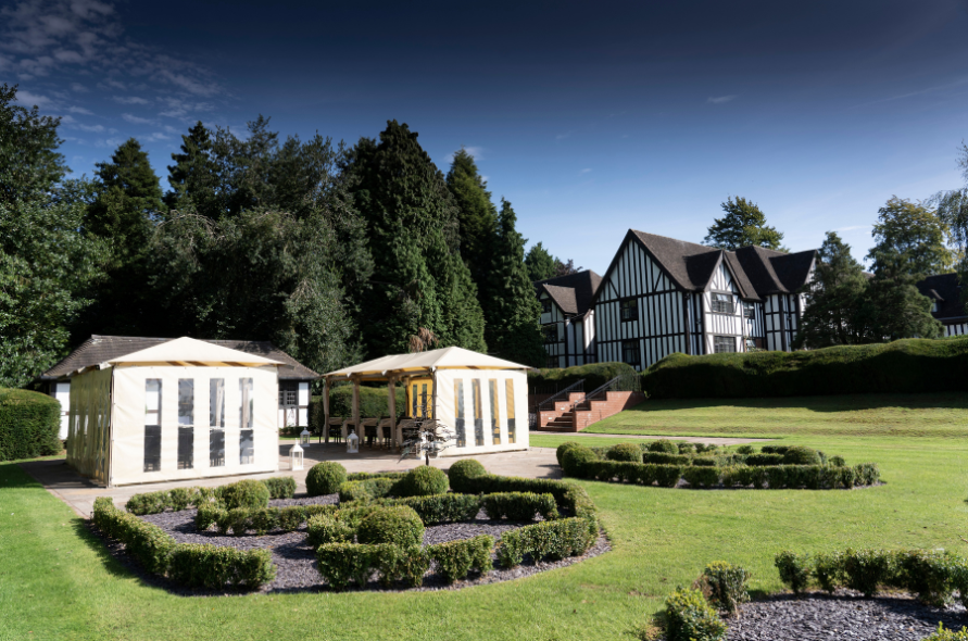 Scenic view of Stone Manor with manicured gardens and a marquee set up for weddings at Stone Manor
