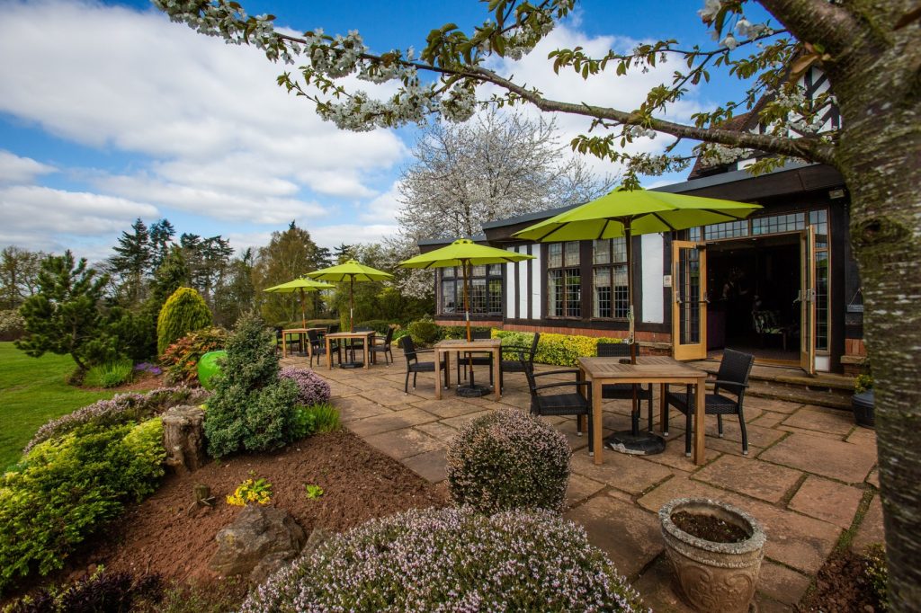 Outdoor seating terrace with countryside views at Stone Manor, ideal for pre-wedding drinks or receptions.